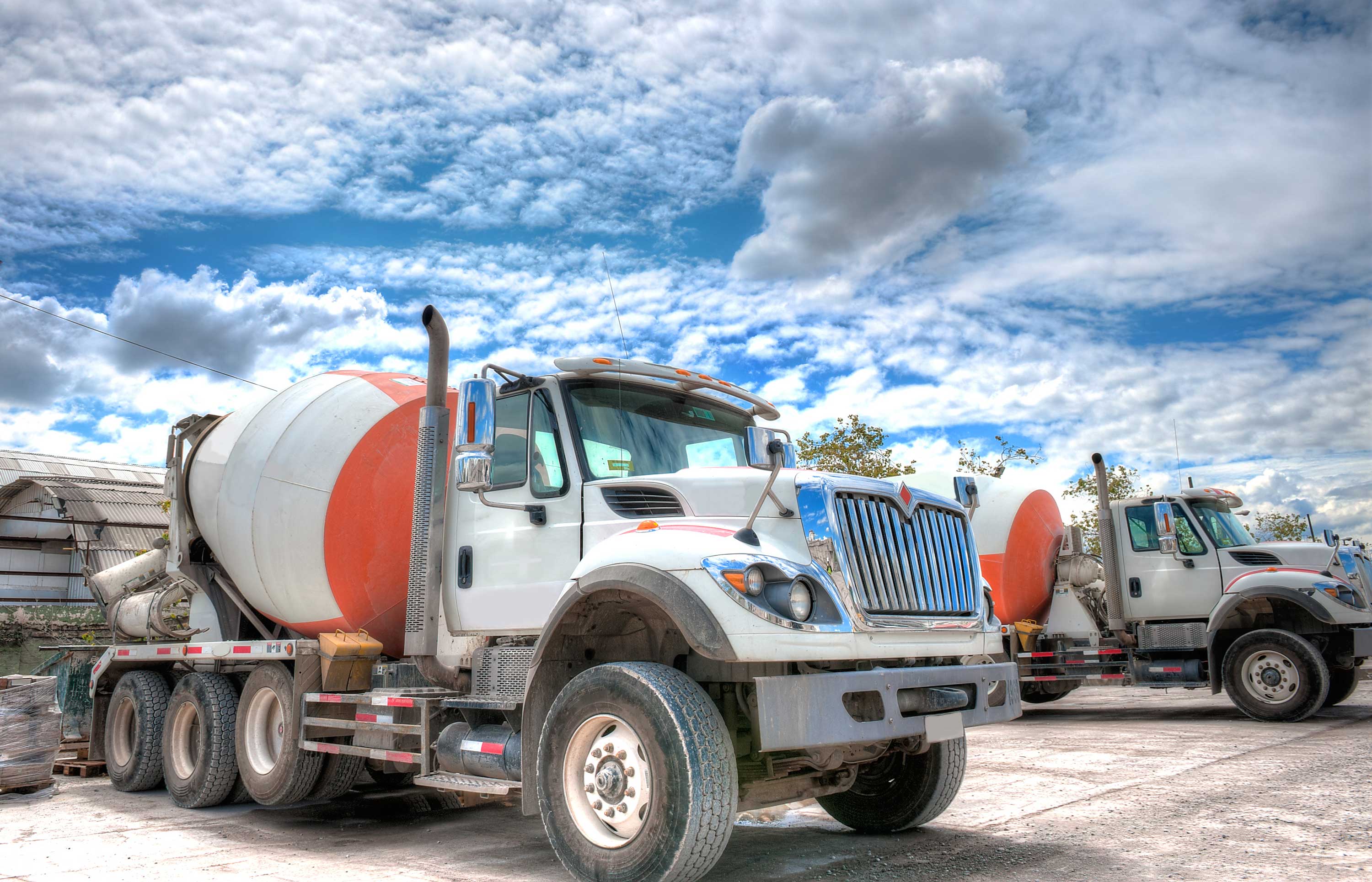 Mixer truck with a beautiful cloudscape in the background